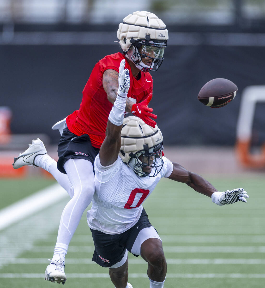 UNLV defensive back Tony Grimes (0) works to break up a pass to wide receiver Jaden Bradley (0) ...