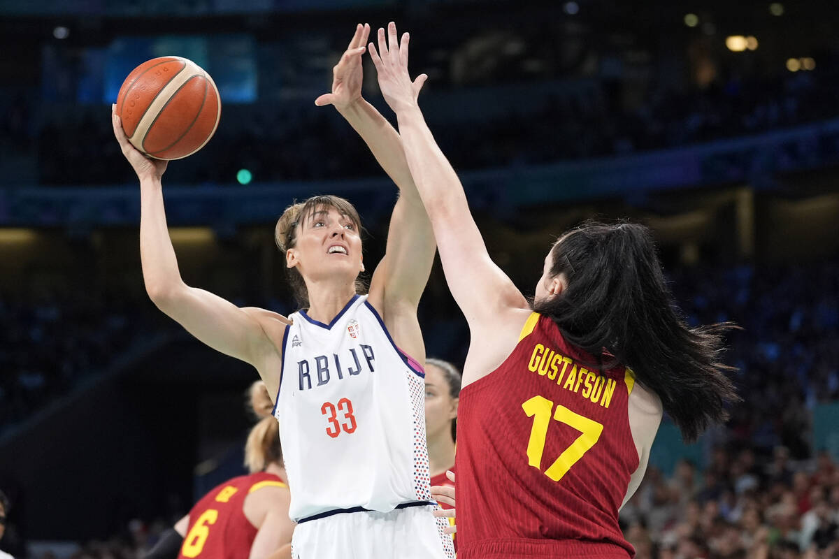 Serbia's Tina Kajisnik, left, shoots as Spain's Megan Gustafson defends during a women's basket ...