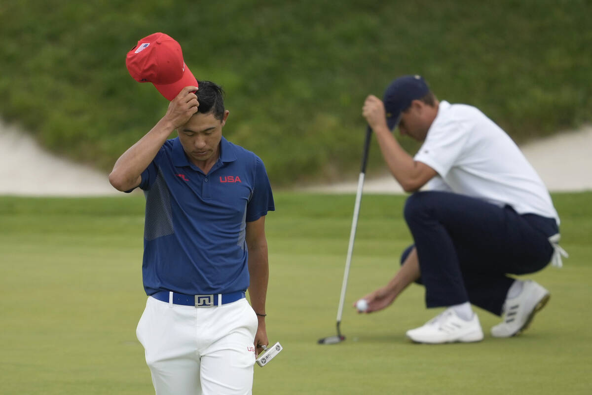 Collin Morikawa, of the United States, walks off the 11th green after putting during the third ...