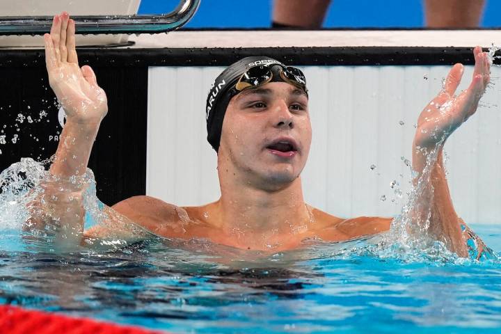 Canada's Ilya Kharun celebrates winning the bronze medal in the men's 100-meter butterfly final ...