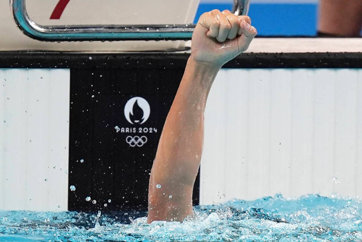 Canada's Ilya Kharun celebrates winning the bronze medal in the men's 100-meter butterfly final ...