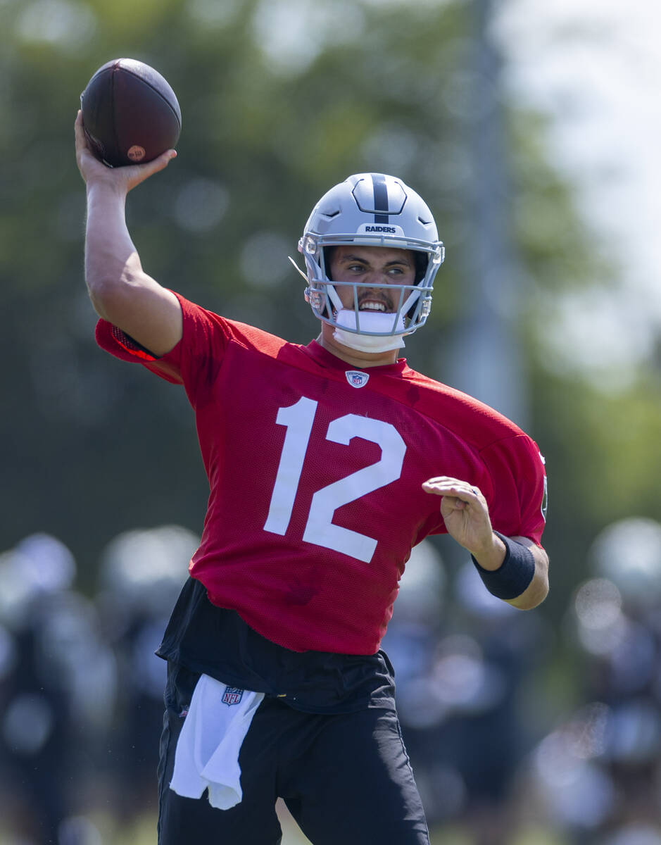 Raiders quarterback Aidan O'Connell (12) eyes a receiver during the first day of training camp ...