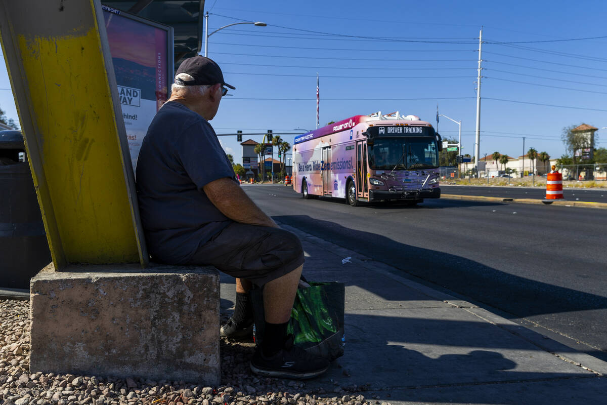 A rider watches a bus moving northbound past a stop along the Maryland Parkway as the $378 mill ...