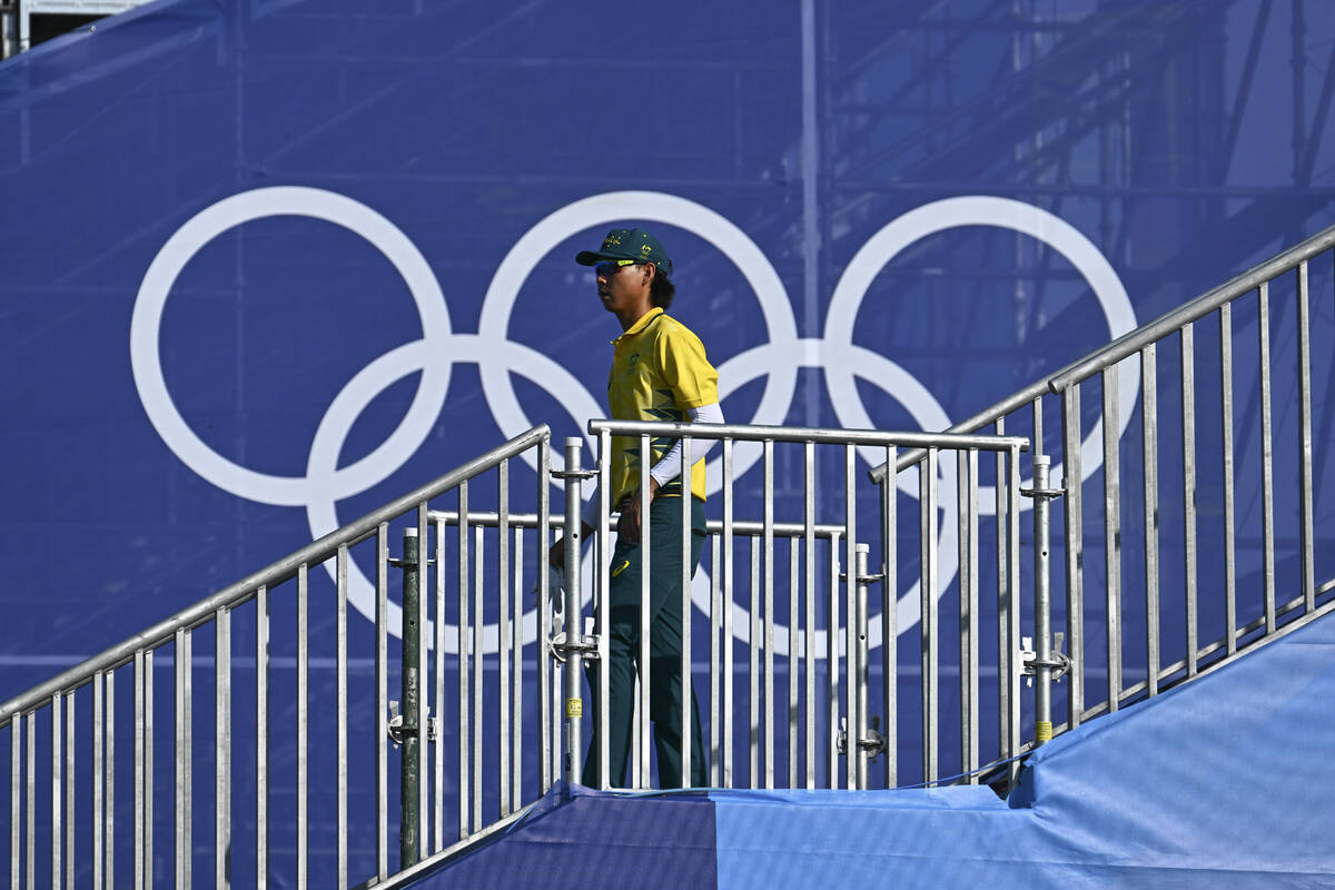 Min Woo Lee of Team Australia walks to the first tee during the first round of the 2024 Paris O ...