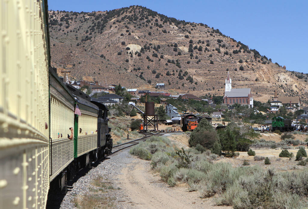 Being pulled by steam engine #18, the Virginia & Truckee train pulls into the station in Virgin ...