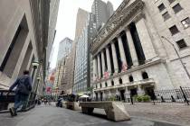 FILE - People pass the New York Stock Exchange on July 30, 2024 in New York. Japan's benchmark ...