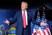 FILE - Republican presidential candidate former President Donald Trump gestures to the crowd as ...