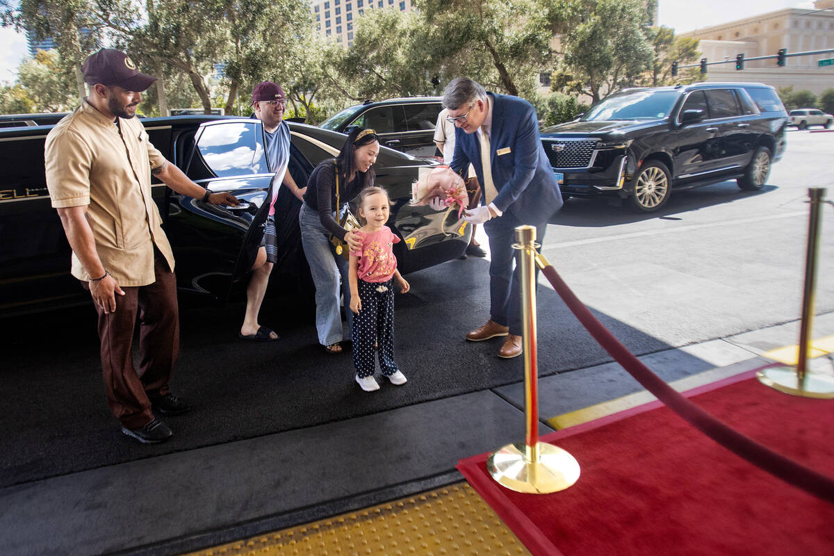 Samantha Buckley, 5, right, exits the vehicle with her parents and is greeted with flowers and ...