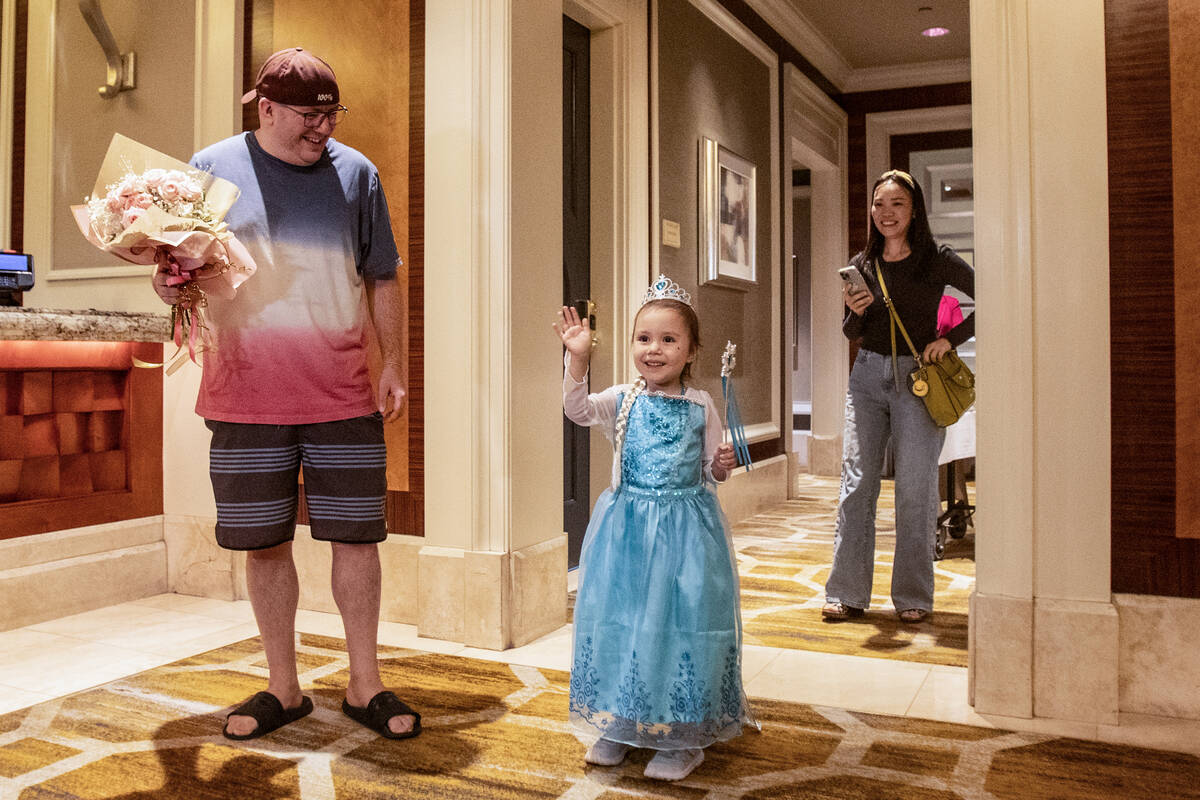 Joined by her parents William Buckley, left, and June Chen, Samantha Buckley, 5, waves while dr ...