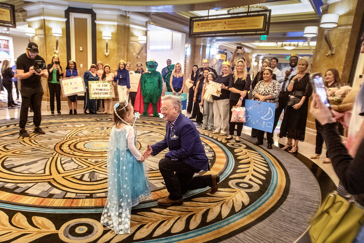 Samantha Buckley, 5, left, is greeted by President and CEO of Make-A-Wish Southern Nevada Scott ...