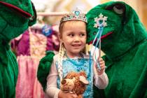 Samantha Buckley, 5, takes a photograph with royal frogs during a Make-A-Wish Southern Nevada t ...