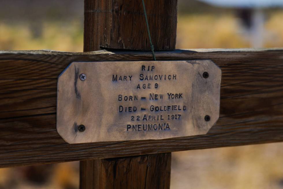 A handmade plaque is seen on a grave in the Goldfield Cemetery on Saturday, Aug. 3, 2024, in Go ...