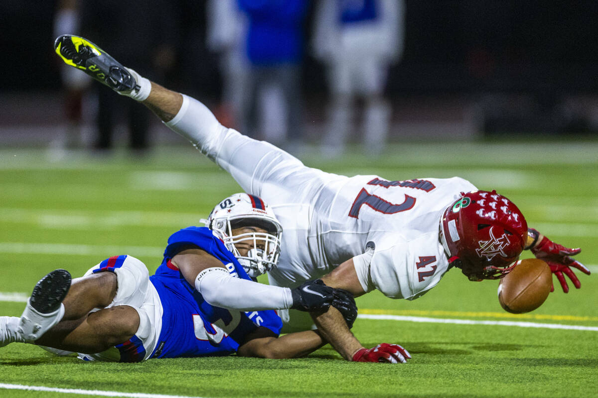 Arbor View MLB Christian Thatcher (42) dives for a fumble as Liberty RB Isaiah Lauofo (3) holds ...