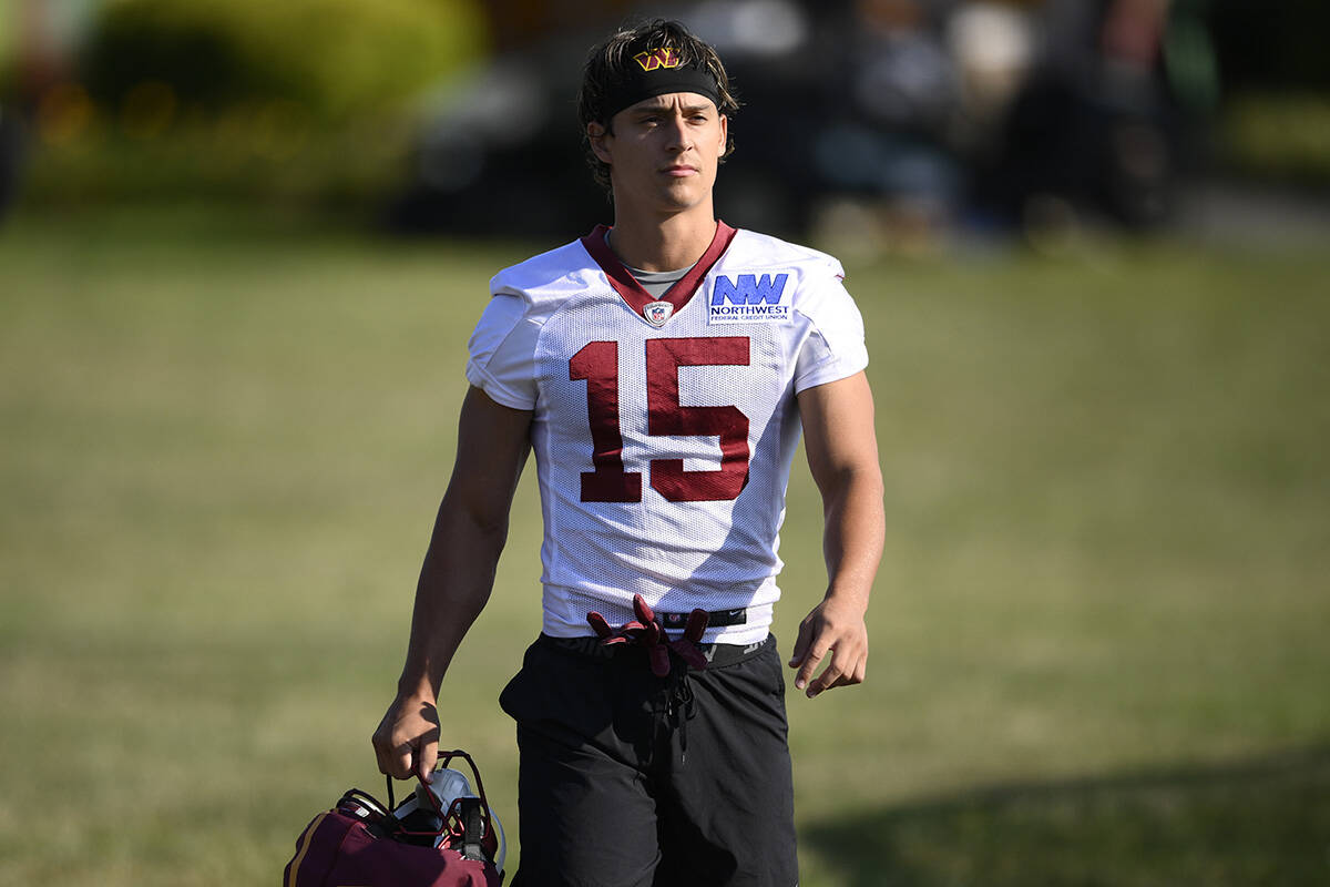 Washington Commanders wide receiver Dax Milne (15) walks to the field for NFL football training ...