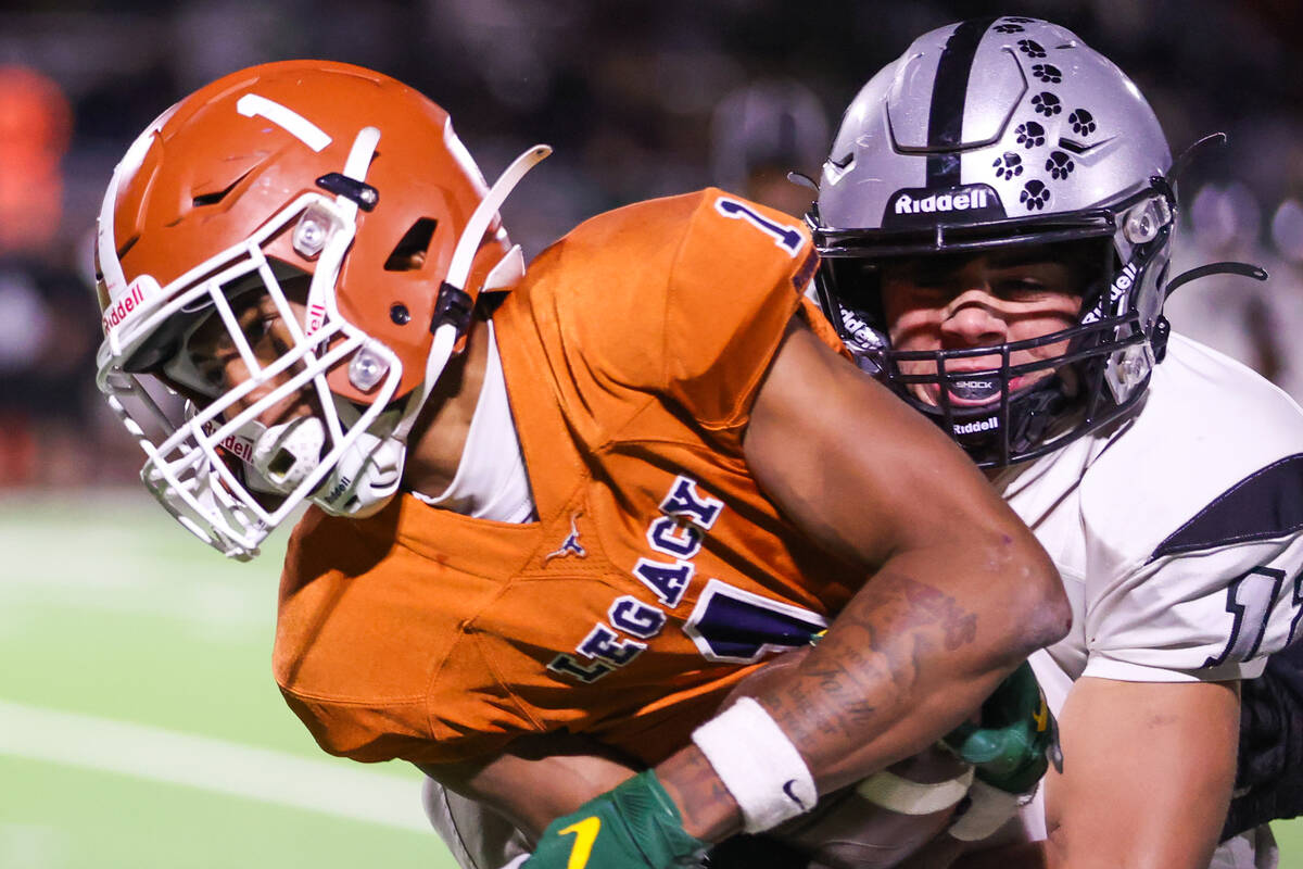 Palo Verde’s Gunnar Gooch (12) tackles Legacy’s Dominic Oliver (1) during the Cla ...