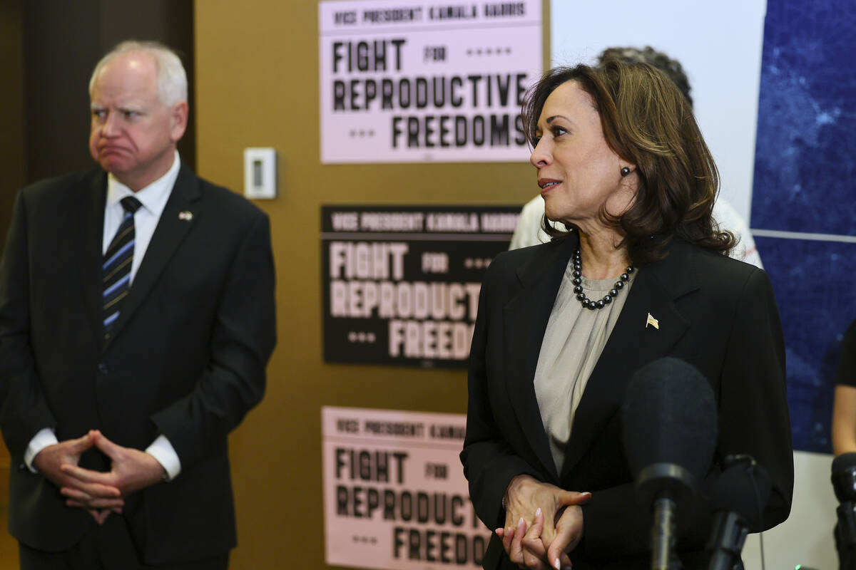 FILE - Minnesota Governor Tim Walz listens to Vice President Kamala Harris speak at Planned Par ...