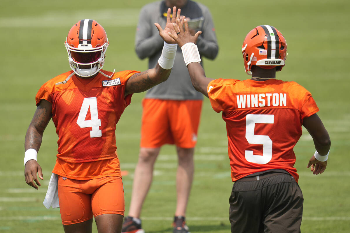 Cleveland Browns quarterbacks Deshaun Watson (4) and Jameis Winston (5) high-five during an NFL ...