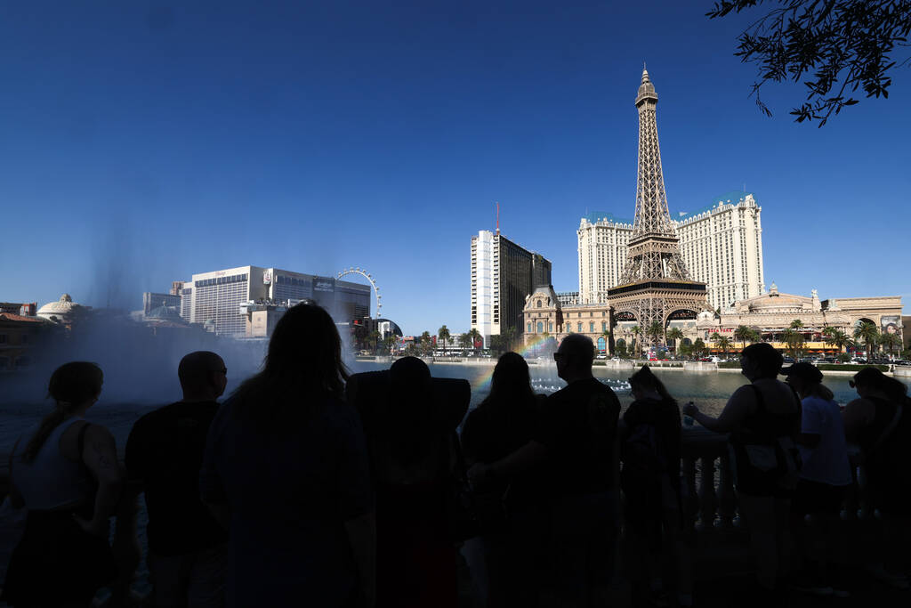 Visitors to the Las Vegas Strip view the Bellagio Fountains from the shade on Friday, June 7, 2 ...