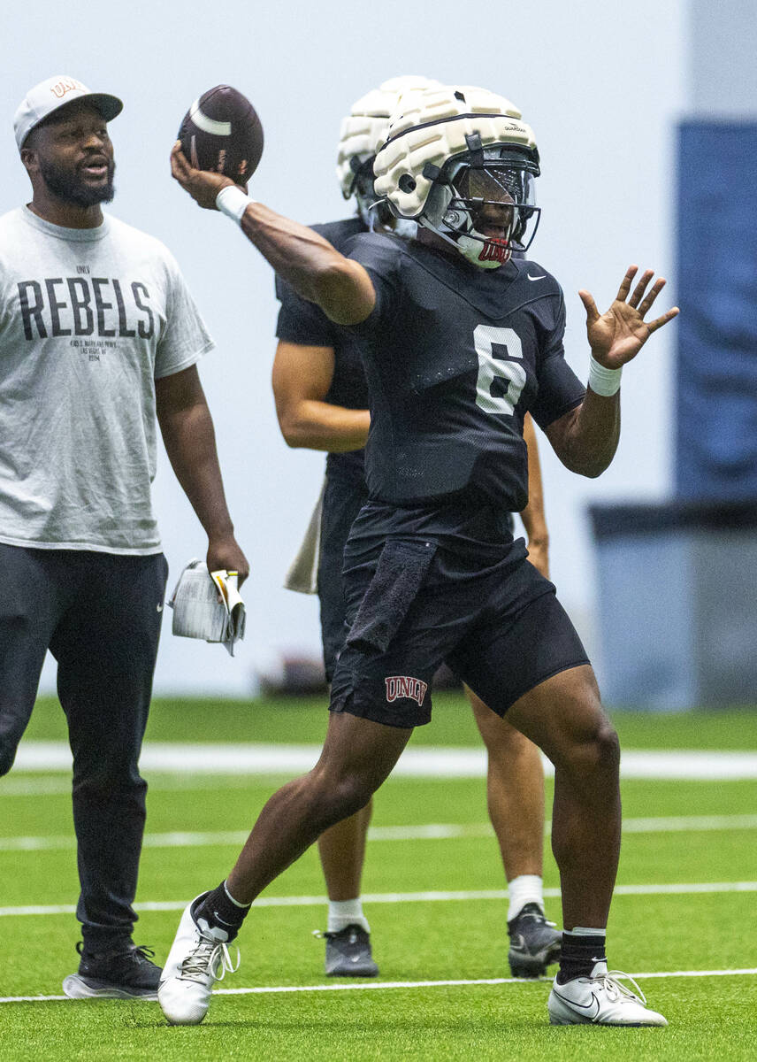 UNLV quarterback Hajj-Malik Williams (6) eyes a receiver for a throw during football practice a ...