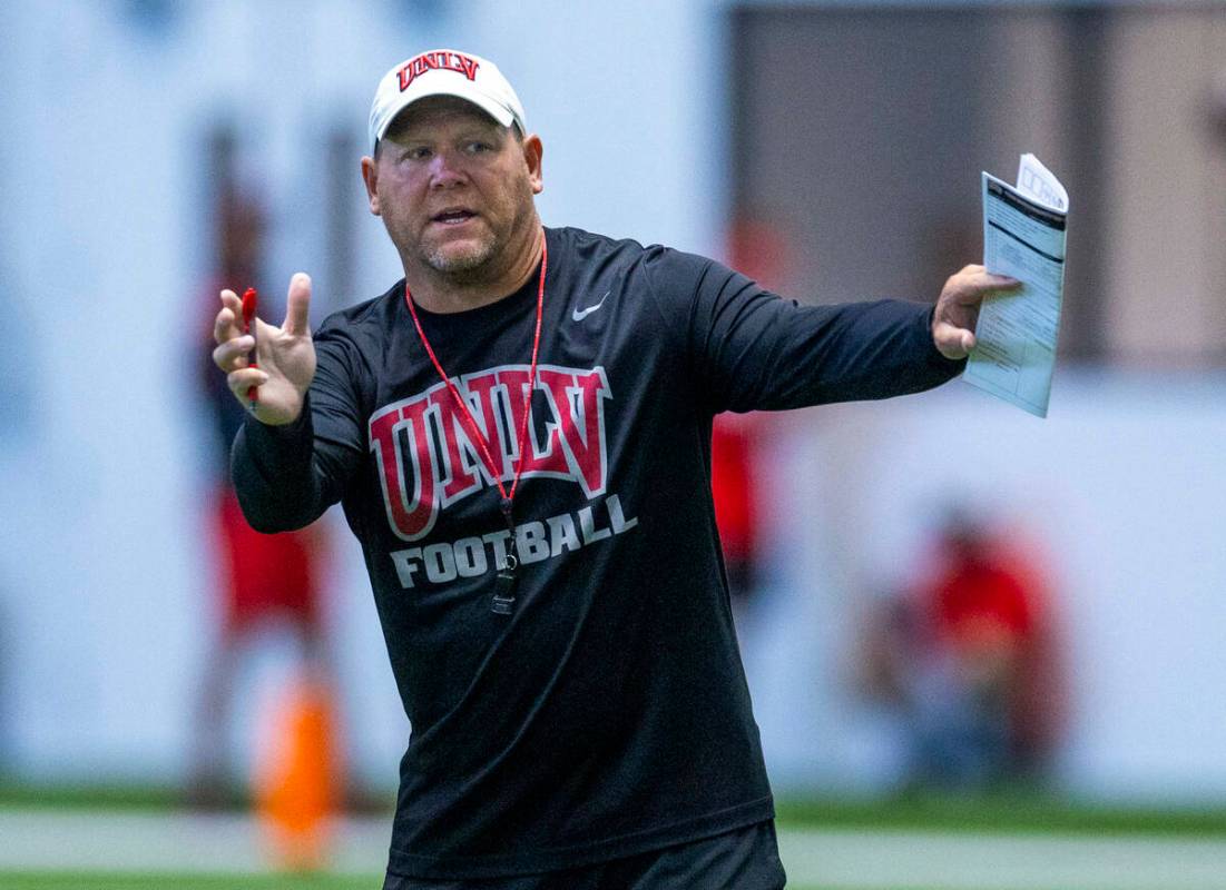 UNLV head coach Barry Odom instructs his players during football practice at the Intermountain ...