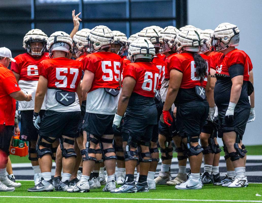 UNLV offensive players come together during football practice at the Intermountain Health Perfo ...