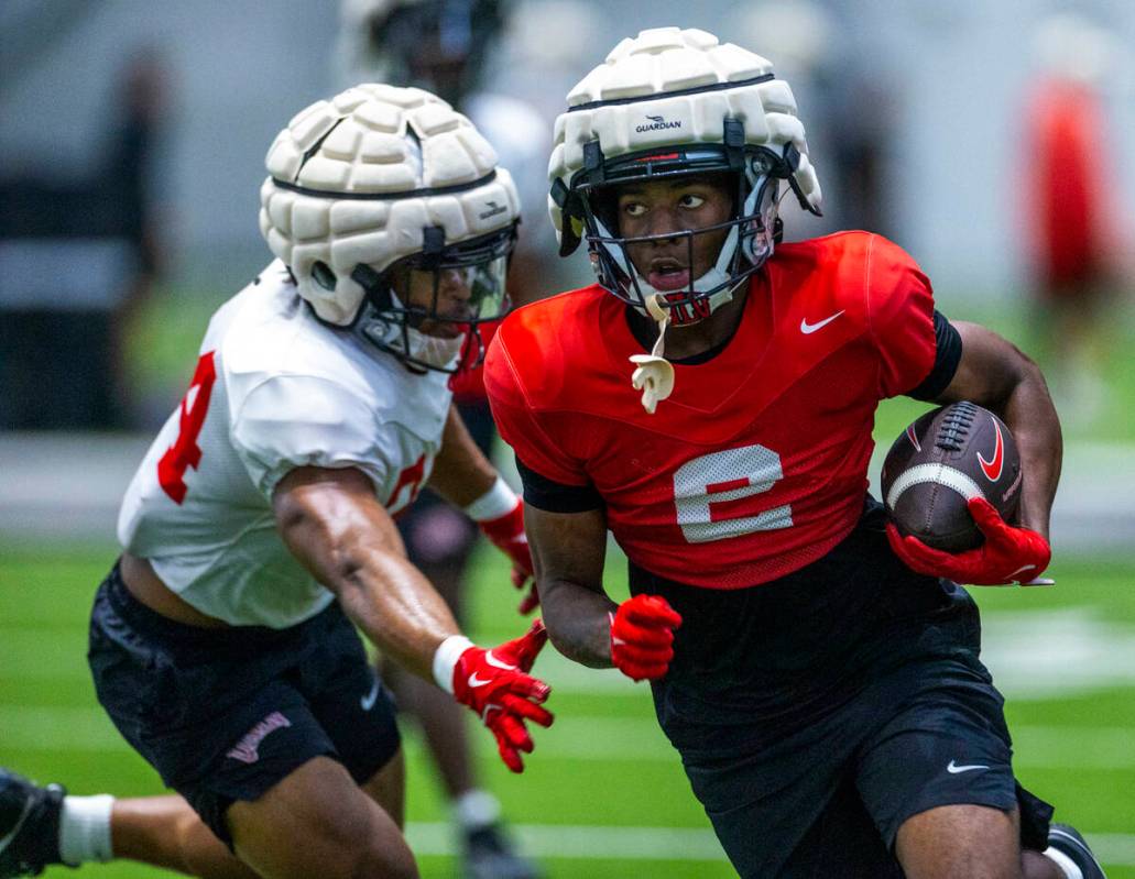 UNLV wide receiver Damien McDaniel (2) works to evade a tackle by linebacker Tyray O'Dell (34) ...