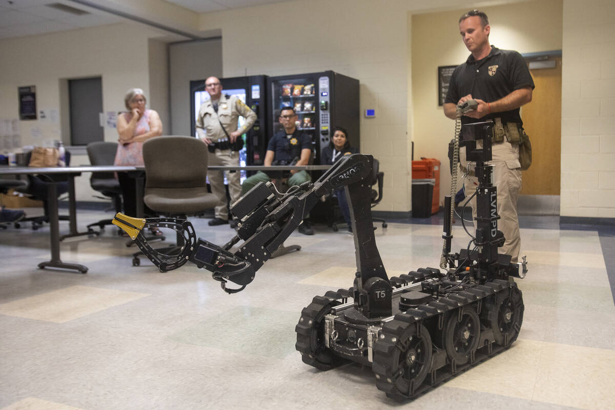 Skyler Lee, of the Las Vegas Metro Police Department ARMOR division, controls the T5 robot to d ...