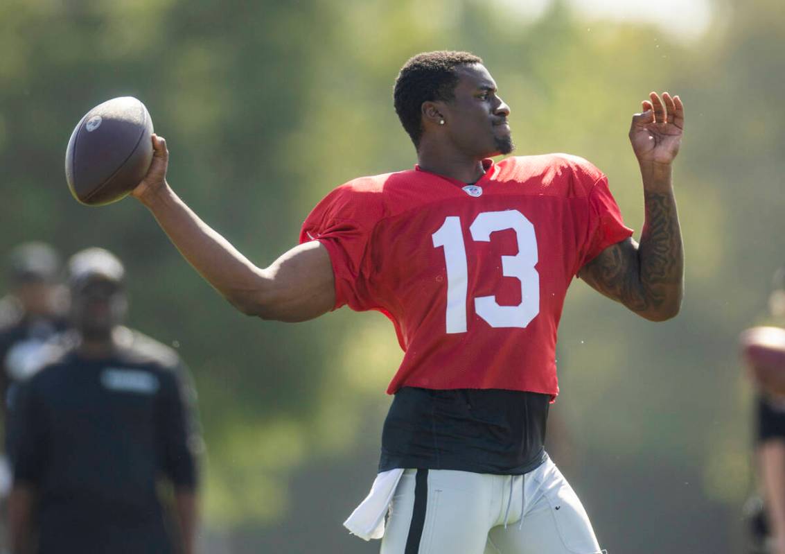 Raiders quarterback Anthony Brown Jr. (13) eyes a receiver during the third day of Raiders trai ...