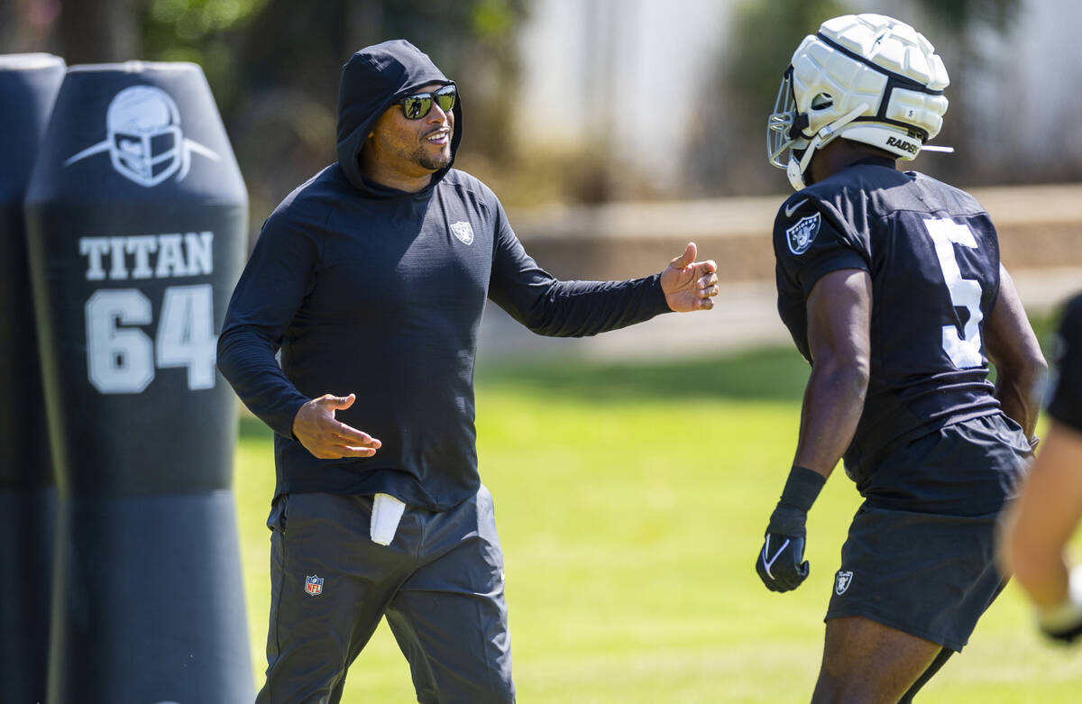 Raiders head coach Antonio Pierce works with linebacker Divine Deablo (5) on a drill during the ...