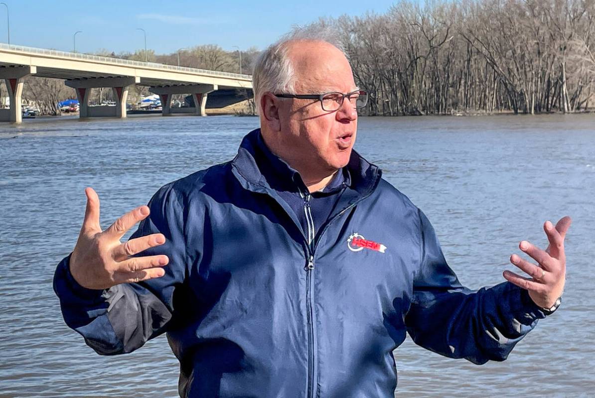 Minnesota Gov. Tim Walz speaks as he checks on flood preparations along the Mississippi River i ...