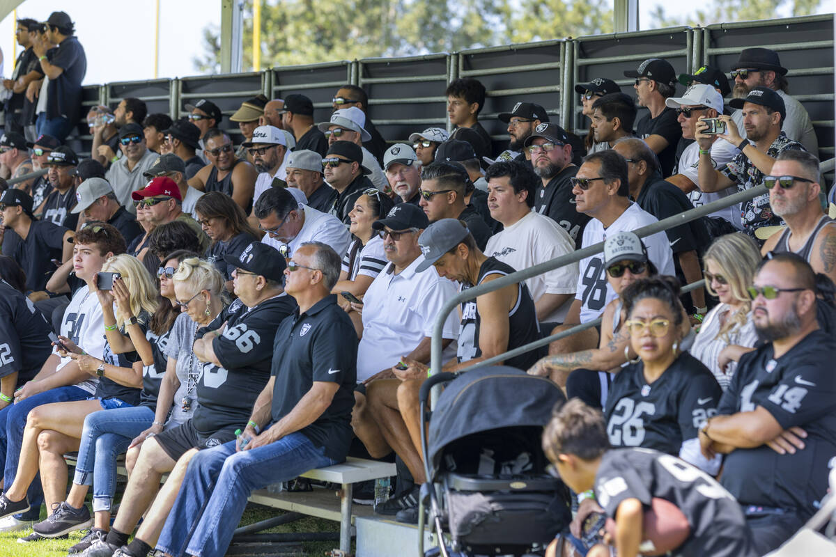 Raiders fans watch players practice during the first day of training camp at the Jack Hammett S ...