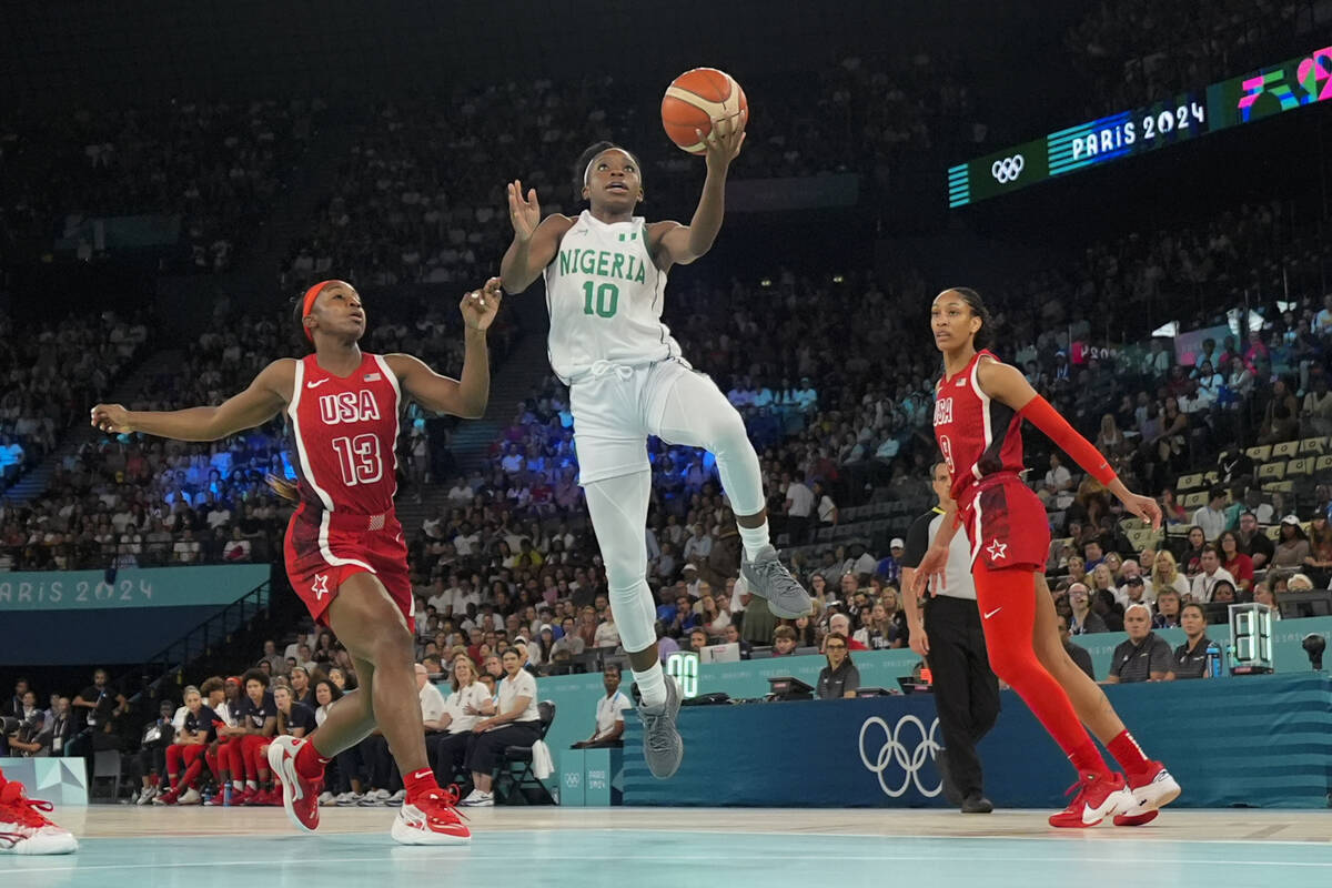 Promise Amukamara (10), of Nigeria, shoots between United States' Jackie Young (13) and A'ja Wi ...