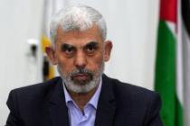 FILE - Yahya Sinwar chairs a meeting with leaders of Palestinian factions at his office in Gaza ...