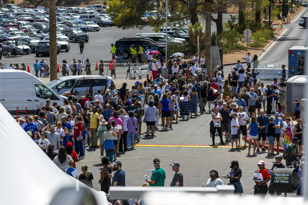 Attendees line up around the building to enter as Vice President Kamala Harris and her running ...