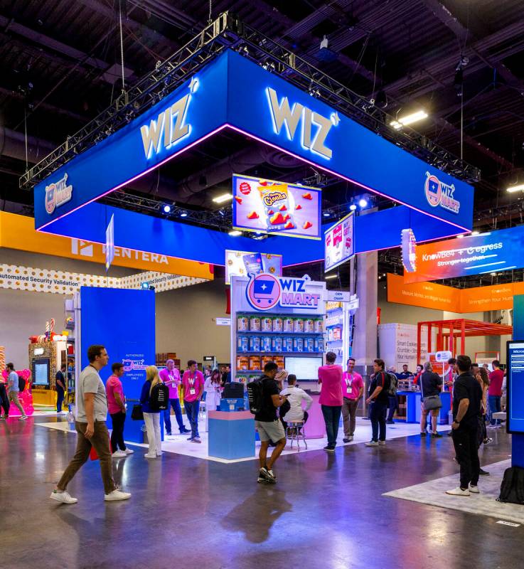 The Wiz Cyber Security display is set in the like of Omega Mart as attendees wander about durin ...