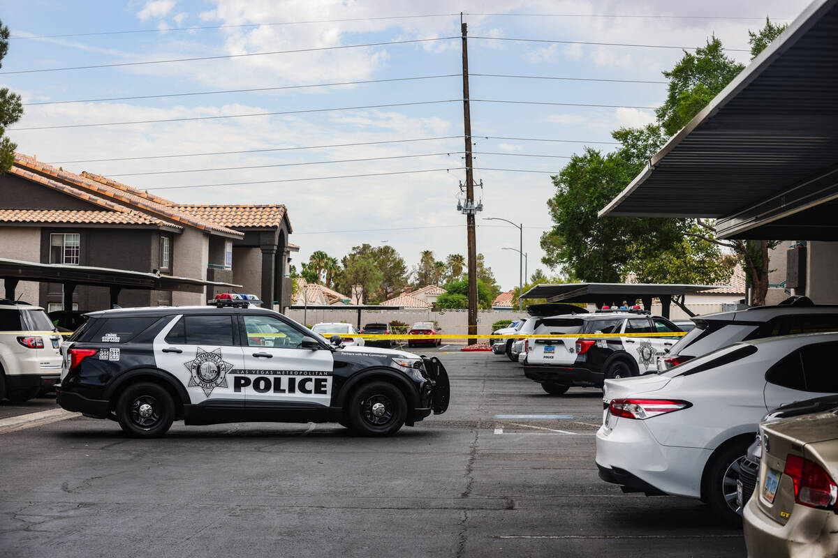 Police at the scene where one person died after a shooting at an apartment complex in west Las ...