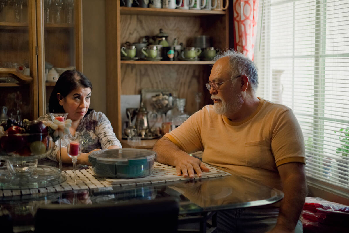 Graciela Nevárez (left) and Juan José Nevárez (right) are talking at the dining ...