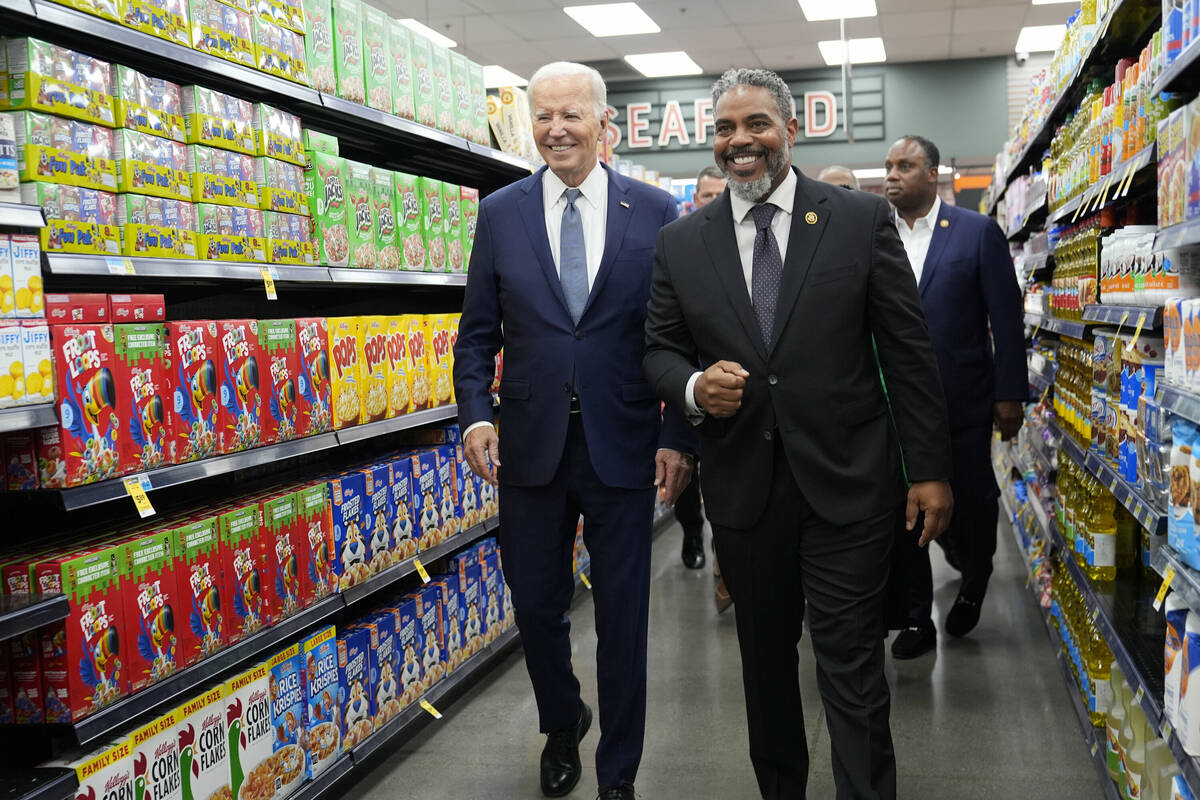 President Joe Biden walks with Rep. Steve Horsford, D-Nev., as he visits Mario's Westside Marke ...