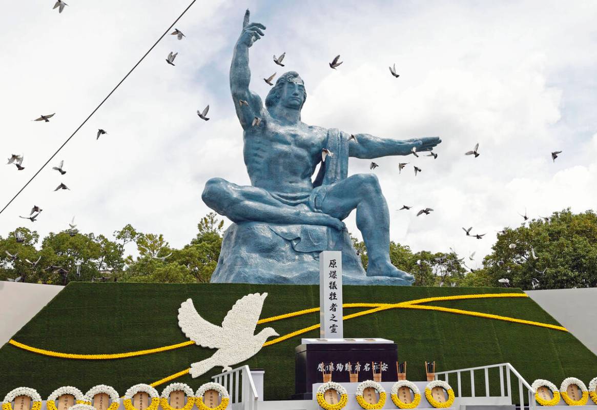 FILE - Doves fly over the Peace Statue during a ceremony to mark the 77th anniversary of the U. ...