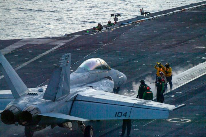 In this photograph released by the U.S. Navy, an F/A-18 Super Hornet prepares to launch off the ...