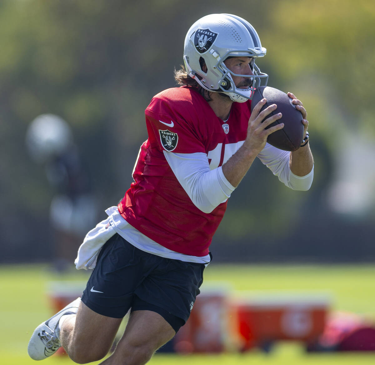 Raiders quarterback Gardner Minshew (15) grabs a ball and looks to pass during the first day of ...