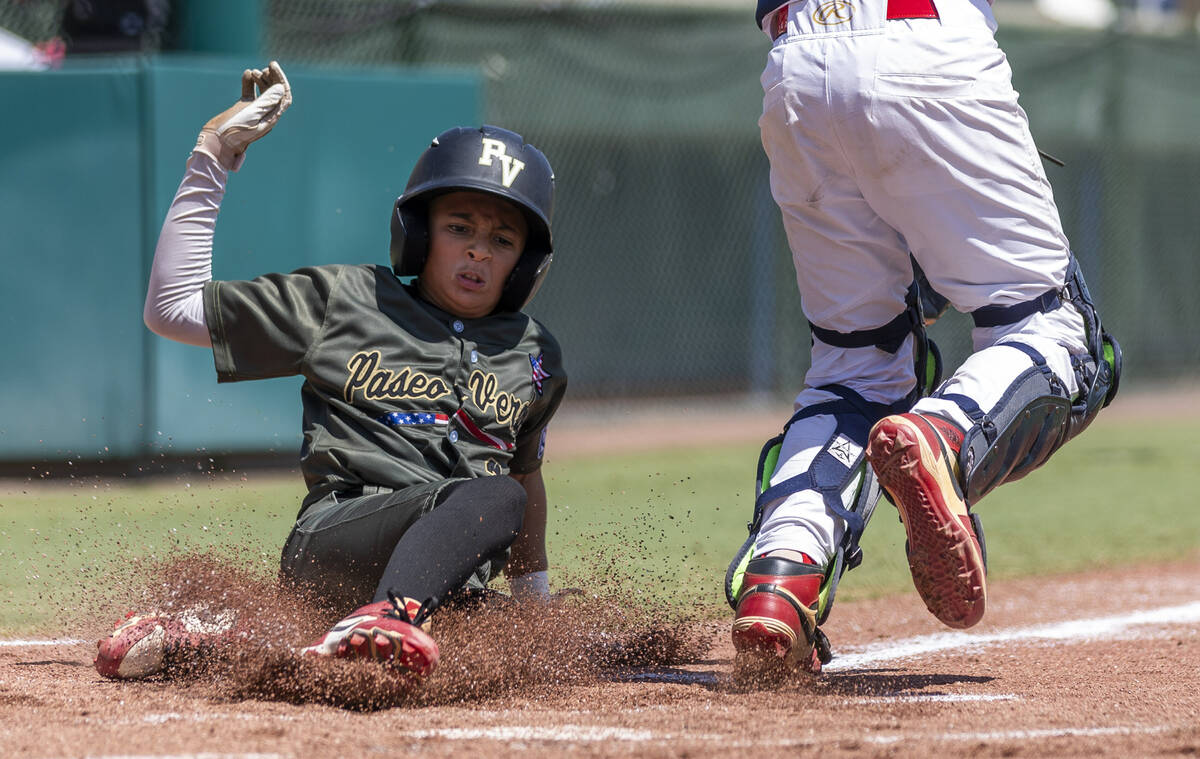 Nevada's Russell McGee (2) slides safely home for the first run against Utah during the first i ...