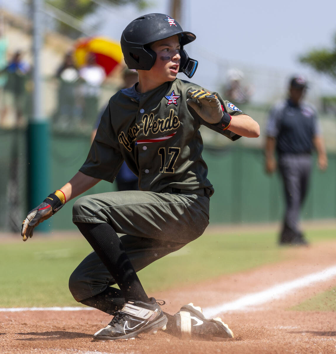 Nevada outfielder Dominic Laino (17) looks to a teammate after he slides safely into home again ...