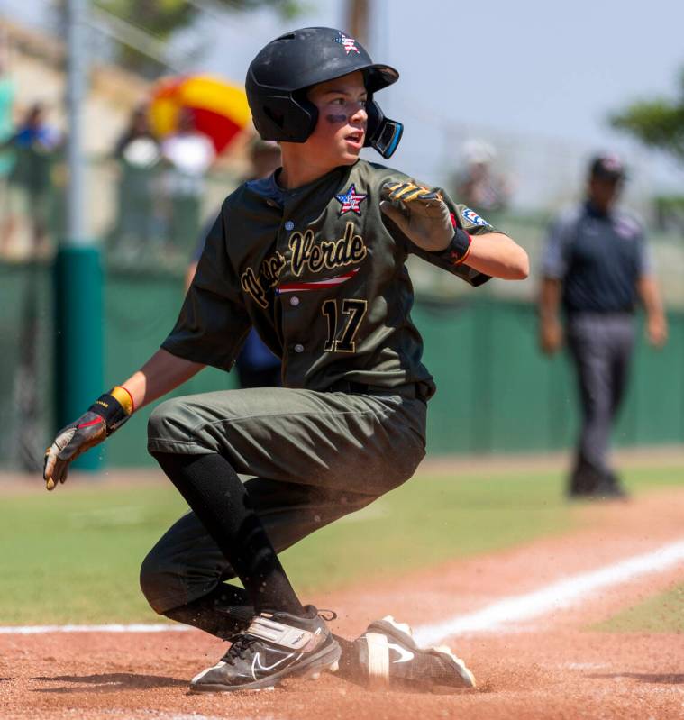 Nevada outfielder Dominic Laino (17) looks to a teammate after he slides safely into home again ...