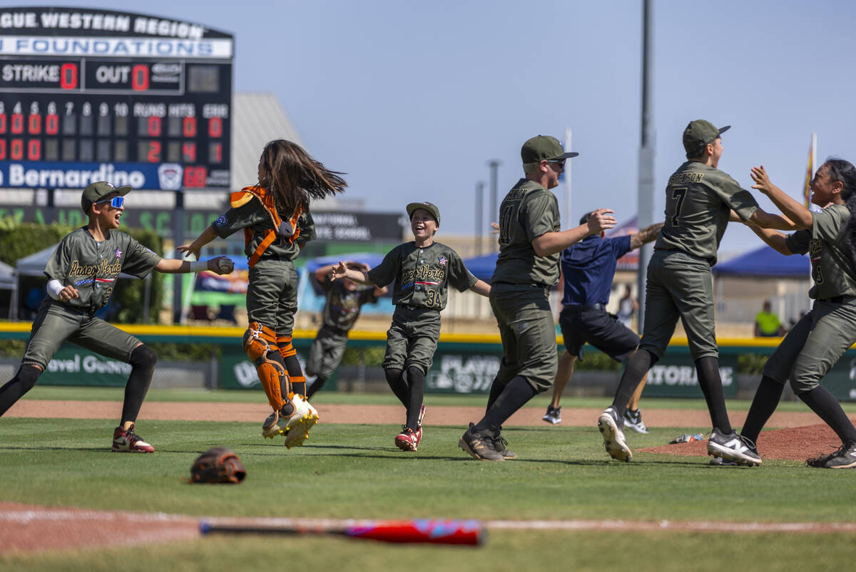 Nevada players celebrate their 2-0 win over Utah in the Mountain Regional final baseball game o ...