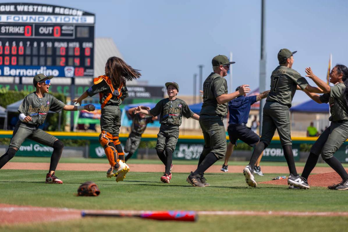 Nevada players celebrate their 2-0 win over Utah in the Mountain Regional final baseball game o ...