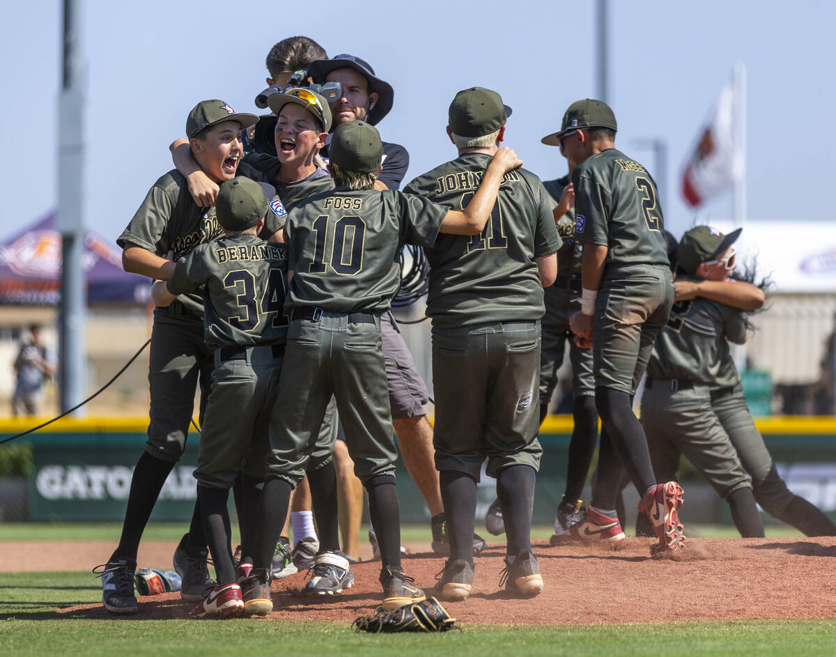 Nevada players celebrate their 2-0 win over Utah in the Mountain Regional final baseball game o ...