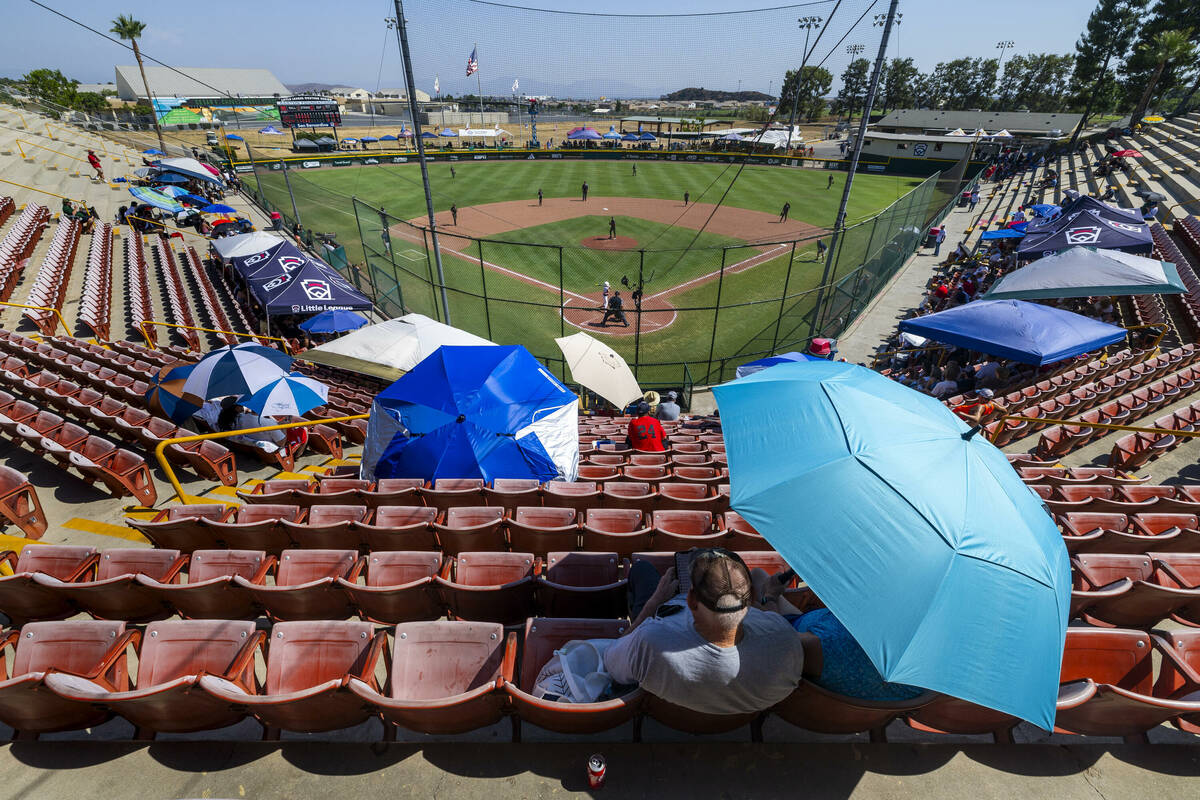 Fans do their best to stay cool in the hot stands as Nevada dominates Utah during the sixth inn ...