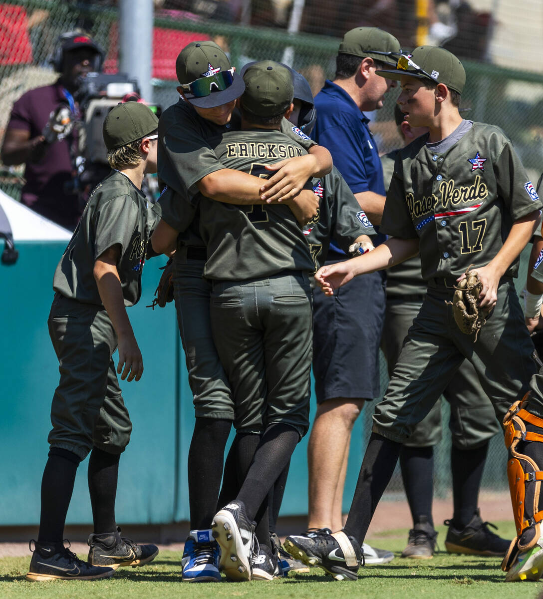 Nevada infielder Oliver Johnson (11) hugs pitcher Wyatt Erickson (7) against Utah during the se ...