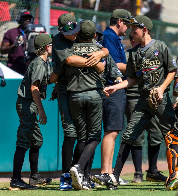 Nevada infielder Oliver Johnson (11) hugs pitcher Wyatt Erickson (7) against Utah during the se ...